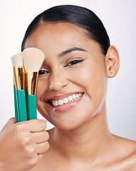 Image showing Brush for makeup, face and beauty with happy woman, foundation and portrait isolated on studio background. Female model smile, natural cosmetics and skin glow with cosmetic tools and cosmetology