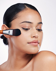 Image showing Beauty, makeup brush and face of a woman in studio for skin glow, cosmetology and cosmetics. Aesthetic female model with cosmetic tools in hand for self care and facial shine on a white background