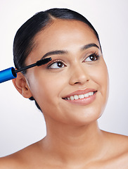 Image showing Mascara, makeup for lashes and beauty with woman and face, eyelash extension isolated on studio background. Female model smile, cosmetics brush and skin glow with cosmetic product and cosmetology