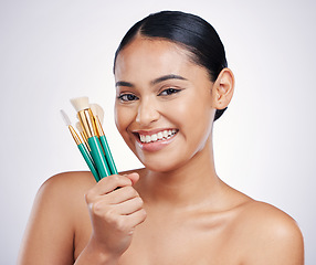 Image showing Makeup brushes, face and beauty, woman with smile, foundation and powder isolated on studio background. Female model in portrait, natural cosmetics and skin glow with cosmetic tools and cosmetology