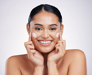 Image showing Happy woman, portrait and smile with cream for skincare, moisturizer or cosmetics against a white studio background. Female person or model smiling for beauty skin product, lotion or facial treatment