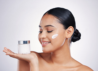 Image showing Happy woman, face cream and product in skincare cosmetics or moisturizer with smile against a white studio background. Female person or model smiling for beauty lotion or facial treatment on mockup