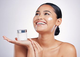 Image showing Happy woman, face and thinking with cream in skincare, moisturizer or cosmetics against a white studio background. Female person model smiling for product, lotion or facial treatment on mockup space