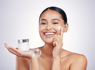 Image showing Happy woman, portrait smile and cream in skincare, moisturizer or cosmetics against a white studio background. Female person or model smiling for product, lotion or facial treatment on mockup space