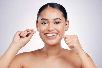 Image showing Happy woman, portrait and dental floss for clean teeth, hygiene or healthcare against a white studio background. Female person or model smiling in flossing, tooth cleaning or oral, gum and mouth care