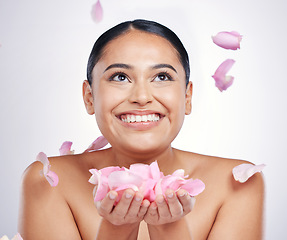 Image showing Flower petals, face and beauty of a woman in studio for skin glow, dermatology and cosmetics. Female person with floral skincare in hand for facial shine, health and wellness on a white background