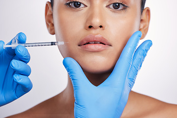 Image showing Woman, needle and studio portrait for lips, surgery or cosmetics for skin, collagen or face by white background. Girl, cosmetic surgeon and filler for mouth, syringe or hands for beauty with skincare