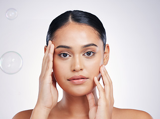 Image showing Beauty, skin and woman with hands on face in studio for glow, dermatology or natural cosmetics. Portrait of aesthetic model person with bubbles for self care, facial or skincare on a white background