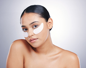 Image showing Face, eye mask and beauty of a woman in studio for glow, dermatology or natural cosmetics. Portrait of model person with collagen skincare patch for facial self care or wellness on a white background