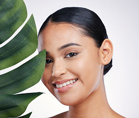 Image showing Happy woman, portrait and face with leaf for natural beauty or skincare against a white studio background. Female person with plant and smile in happiness for nature cosmetics or facial treatment