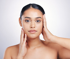 Image showing Beauty, skin and woman with hands on face in studio for glow, dermatology or natural cosmetics. Headshot of aesthetic model person with self care, facial or skincare results on a white background