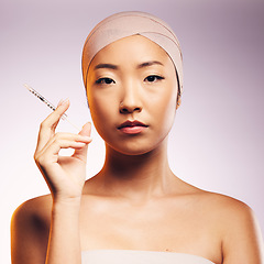Image showing Woman, portrait and plastic surgery with injection, bandage and asian model in studio background. Serious woman, syringe and face with collagen for aesthetic, cosmetics and facial beauty treatment.