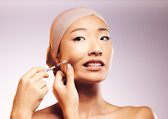 Image showing Woman, bandage and plastic surgery with injection on face in studio background for asian beauty. Model, skincare filler and collagen with cosmetic treatment, syringe and cheek for facial facelift.