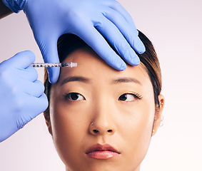 Image showing Forehead injection, face skincare and Asian woman in studio isolated on a white background. Cosmetics, syringe and female model with collagen filler, dermatology and prp facelift in plastic surgery.