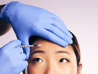 Image showing Face skincare, forehead injection and Asian woman in studio isolated on a white background. Cosmetics, syringe and female model with collagen filler, dermatology and prp facelift in plastic surgery.