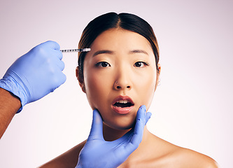 Image showing Face skincare, injection surprise and Asian woman in studio isolated on a white background. Cosmetics, syringe and female model with collagen filler, portrait and wow for facelift plastic surgery.