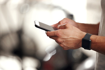 Image showing Fitness, typing and man with phone, smart watch and workout schedule at gym for sports training. Athlete checking social media, tracker or website for exercise and health on cellphone application.