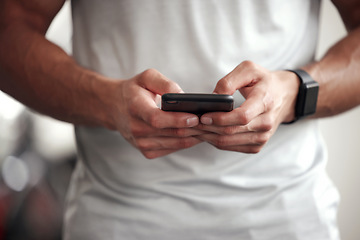 Image showing Fitness, app and man with phone, checking workout schedule or social media at gym for sports training. Athlete with digital application, heart rate tracker and exercise tech, health and cellphone.