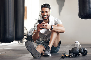 Image showing Fitness, man with smartphone and earphones at the gym happy for training or health wellness. Meditation or commitment, exercise or workout and male athlete listen to music or podcast for motivation