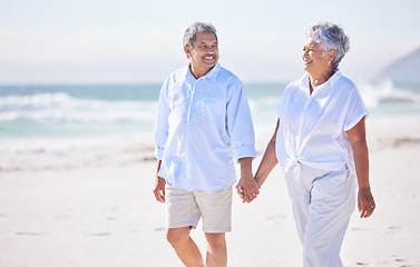 Image showing Holding hands, beach or happy old couple walking in summer with happiness, trust or romance. Lovers, smile or senior man enjoying bonding time with mature woman taking a walk on sand at sea or ocean
