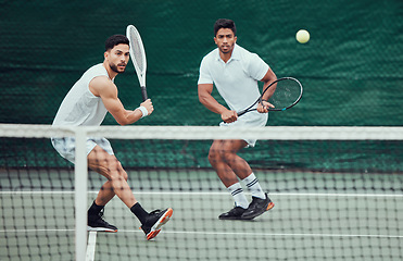 Image showing Male team, ball and tennis court during a competition in india for fitness, health and sport. Man, athlete and together with action for game with training and a challenge for wellness in the outdoor.