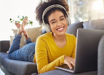 Image showing Laptop, headphones and woman portrait on sofa for e learning, online education and music streaming on website service. Happy student or african person on couch, audio technology and computer for home