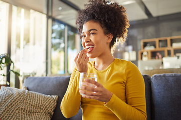 Image showing Glass, water and woman with medicine on sofa for health, self care and supplement at home. Relax, healthcare and happy african person with liquid drink and pill or tablet for wellness on couch