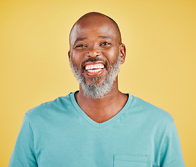 Image showing Mature african man, laugh and studio portrait with happiness, comic and funny by yellow background. Senior model, happy and smile with excited face, fashion and t-shirt with confidence by backdrop