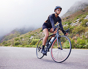 Image showing Road, woman and cycling with fitness, health and training for wellness, cardio and endurance. Female person, biker and cyclist with workout, street and practice with a helmet, glasses and exercise