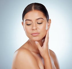 Image showing Face, smooth skincare and beauty of woman in studio isolated on a white background. Natural, serious and female model in makeup, cosmetics or facial treatment for skin health, aesthetic or wellness.