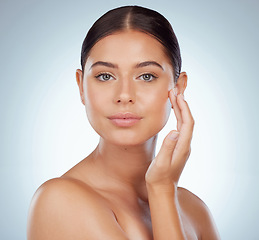 Image showing Smooth face, skincare and woman in studio isolated on a white background. Natural beauty, portrait and serious female model in makeup, cosmetics or facial treatment for health, aesthetic or wellness.