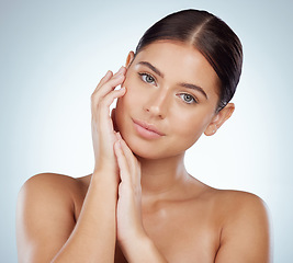 Image showing Face, skincare and hands of woman in studio isolated on white background. Portrait, natural beauty and serious female model in makeup, cosmetics or facial treatment for health, aesthetic or wellness