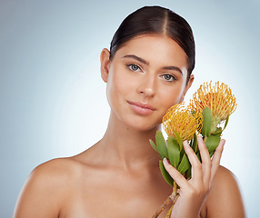 Image showing Face, skincare and woman with protea flowers in studio isolated on a white background. Portrait, natural and female model with floral pincushion plants for makeup, cosmetics and beauty skin treatment