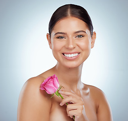 Image showing Skincare, face and woman smile with rose in studio isolated on a white background. Portrait, natural flower and female model with pink floral plant for makeup cosmetics, beauty treatment and wellness