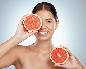 Image showing Skincare, face and woman smile with grapefruit in studio isolated on a white background. Portrait, natural and female model with fruit for vitamin c, nutrition and healthy diet, wellness or cosmetics