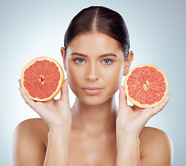 Image showing Serious face, skincare and woman with grapefruit in studio isolated on white background. Portrait, natural and female model with fruit for vitamin c, nutrition or healthy diet, wellness or cosmetics.