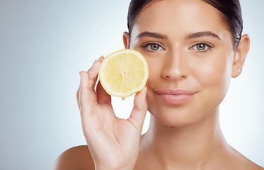 Image showing Beauty skincare, face and woman with lemon in studio isolated on a white background. Portrait, natural or female model with fruit for vitamin c, vegan nutrition or healthy diet, wellness or cosmetics