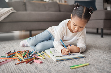 Image showing Young girl, kid and pencils on floor with coloring book in living room for education, learning or creative development. Cute child, books and crayons for writing, drawing or creativity of art project