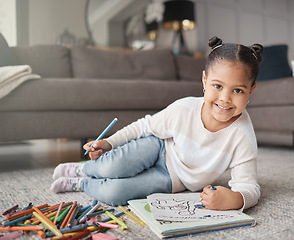 Image showing Portrait of happy kid, girl and pencils for coloring on living room floor for education, learning and creative development. Cute child, books and crayons for writing, drawing and creativity of art