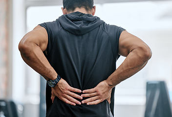 Image showing Fitness, gym and man with hands on back pain, medical emergency and workout at sports studio. Exercise, health and wellness, bodybuilder with hand on muscle burnout or ache for massage while training