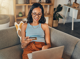 Image showing Woman on sofa with laptop, credit card and online shopping, payment and ecommerce with fintech at home. Happy female customer at apartment, bank app and sale on store website with internet banking