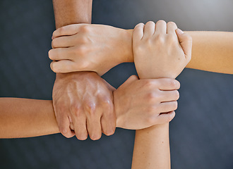 Image showing Hands are together, link and support with solidarity closeup, team and motivation with community and connection. Top view of group huddle, collaboration and unity with respect, trust and teamwork