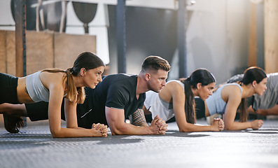 Image showing Gym, fitness and people with plank exercise on floor for strength, resilience and training, focus or mindset. Health club, push up and person group with endurance workout for balance, power or cardio