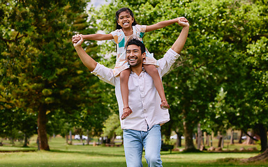 Image showing Indian dad, daughter and shoulders in park with smile, airplane game or piggyback in nature on holiday. Man, girl and playing together in garden, woods and summer sunshine for happy family vacation