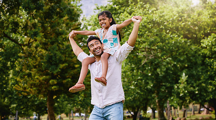 Image showing Indian father, daughter and shoulders in park with smile, airplane game or piggyback in nature on holiday. Man, girl and playing together in garden, woods or summer sunshine for happy family vacation