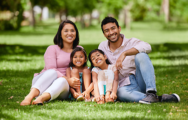 Image showing Relax, portrait and asian family at a park happy, bonding and having fun outdoor together. Face, love and children with parents on forest ground, sitting and cheerful while enjoying nature on weekend