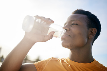 Image showing Fitness, drink and black man with water bottle in exercise, training or outdoor cardio workout. Athlete, drinking and healthy hydration or person relax after running in summer sport practice