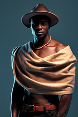 Image showing Portrait, African man with a shawl and against a blue background. Serious or proud, culture clothing and black male fashion model with a hat pose against a studio backdrop with mockup space.