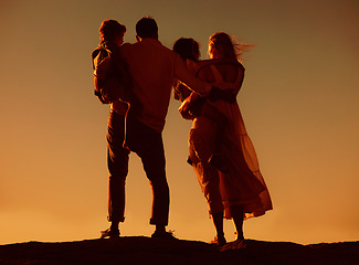 Image showing Parents, children and silhouette on mountain, sunset and hug with love, care and summer adventure. Mother, father and young kids with sky background, bond and outdoor on holiday, vacation or journey