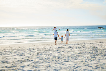 Image showing Happy, holding hands and travel with family at beach for summer, vacation and bonding. Freedom, support and ocean with parents and children walking on seaside holiday for love, care and happiness